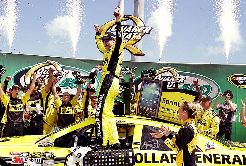 Matt Kenseth celebrates with his crew members after capturing the NASCAR Sprint Cup auto race at Kentucky Speedway in Sparta, Ky., on Sunday.