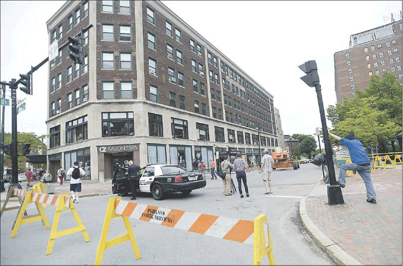 High Street between Congress and Deering streets in Portland is shut down Monday because of the buckling brick facade of the Congress Building. By evening offcials had opened one lane to traffc.
