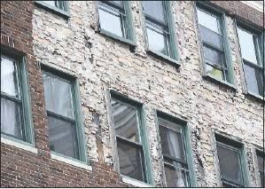 A large patch of bare wall is exposed on the Congress Building at 142 High St. on Monday.