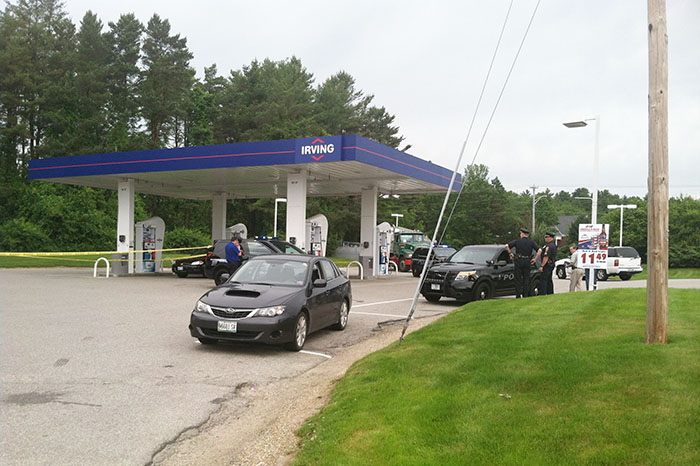 Falmouth police gather evidence at the scene of an armed robbery Friday morning at the Irving gas station at Route 1 and Bucknam Road.