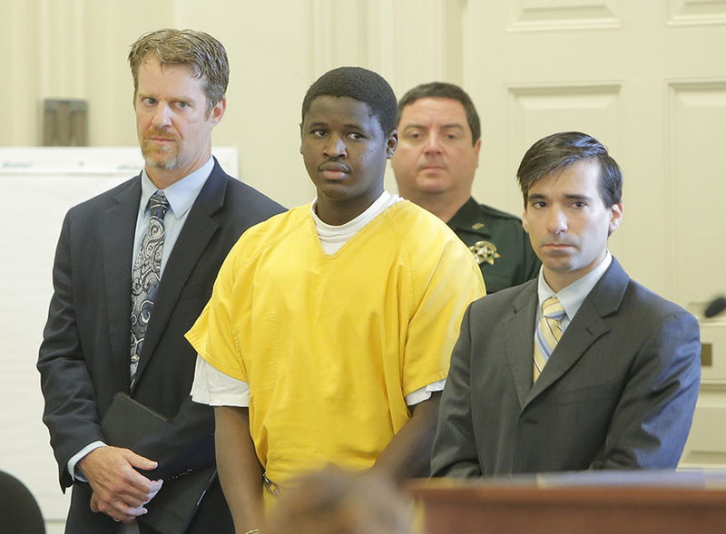 Bub Peter Nguany pleaded not guilty in York County Superior Court in Alfred on Friday to murdering Charles Raybine in Biddeford in this March 26, 2013 file photo. He is flanked by his lawyers Rick Winling, left and Luke Rioux.