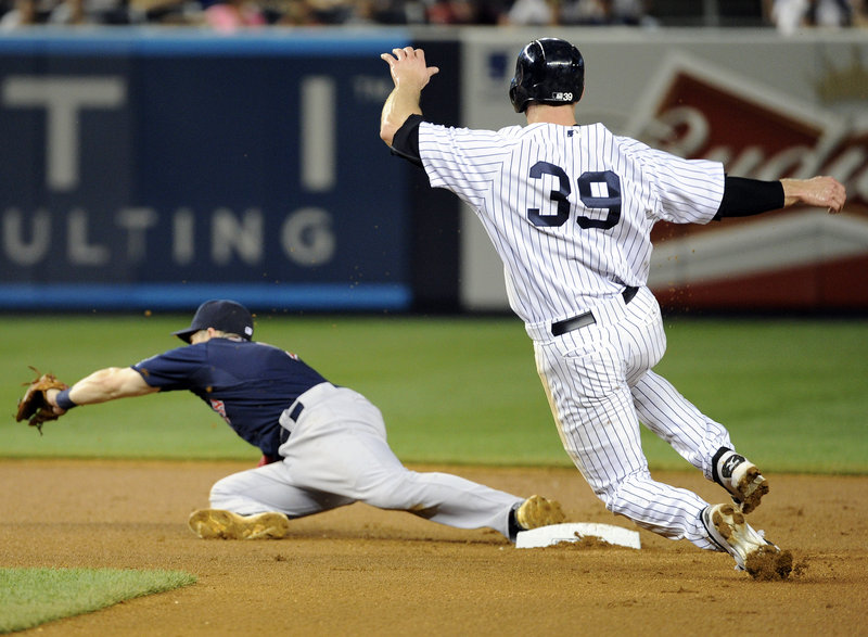 David Adams of the New York Yankees is out at second base Friday night as Red Sox shortstop Stephen Drew takes a throw in the fifth inning. Yankees Manager Joe Girardi was ejected while arguing the call.