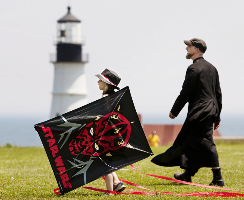 Aubrey Hutchinson, left, and Robert Brown walk near the Portland Head Light during the "Goth Fly a Kite" event.