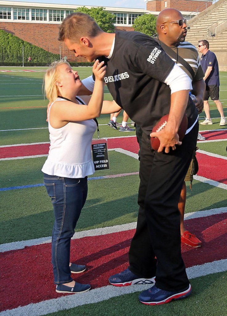 New England’s Tom Brady greets “Glee” cast member Lauren Potter at the Best Buddies charity football game at Harvard on Friday. Patriot Danny Amendola also helped the fundraiser.