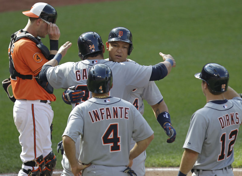 Miguel Cabrera of the Tigers celebrates with teammates after hitting a grand slam – one of four fourth-inning home runs for Detroit in a 10-3 win over the Orioles.