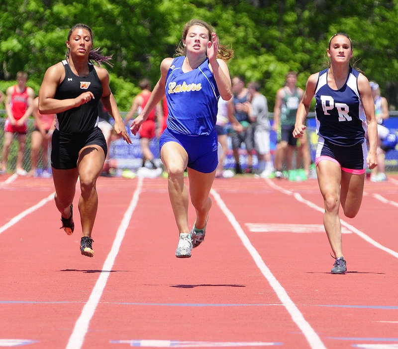 Kate Hall, center, of Lake Region sprints to the finish ahead of Alliyah Veilleux, left, of Winslow to capture the 100-meter title in 12.15 seconds, beating the Class B record she set a year ago.