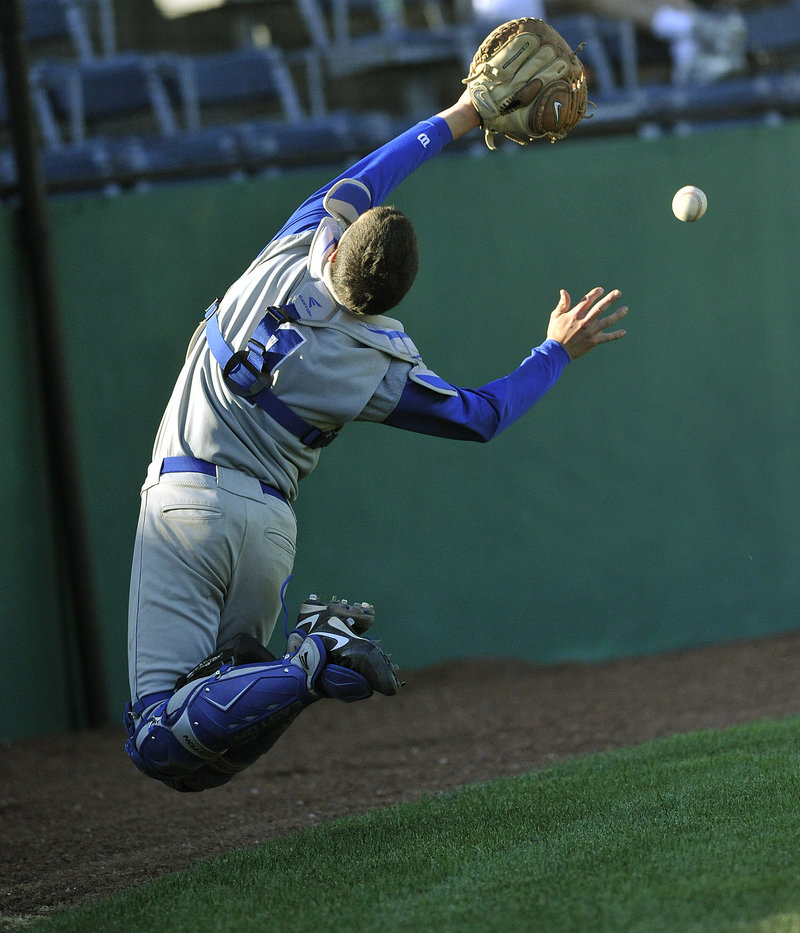 OOB catcher Tim Ellison twists and turns to try to make a circus catch of a foul ball, but comes up short.