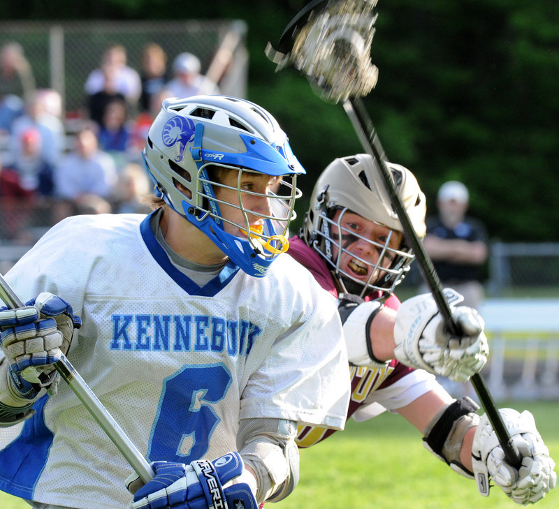 Ryan Keefe is defended by Thornton Academy’s Daniel Giroux during Kennebunk’s 12-8 win Wednesday in a Western Class A quarterfinal.