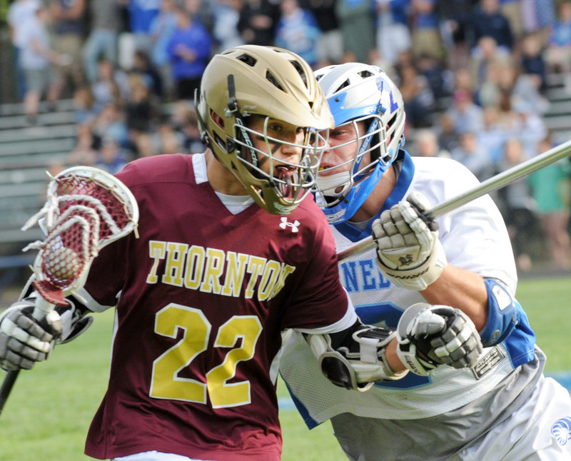Photos by John Patriquin/Staff Photographer Christian Michaud of Thornton Academy tries to dodge Kennebunk’s Nicco DeLorenzo during their Western Class A lacrosse quarterfinal Wednesday. Kennebunk won 12-8.