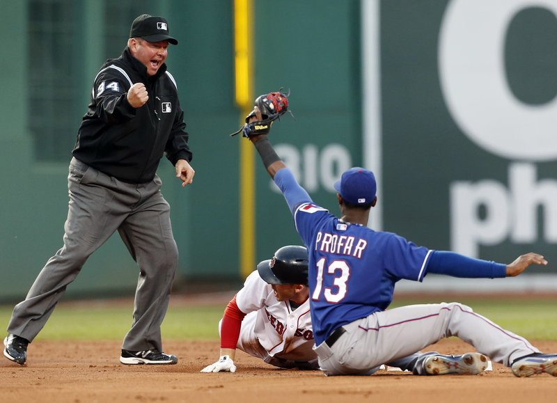 Umpire Sam Holbrook makes the emphatic out call on Boston’s Stephen Drew as Texas’ Jurickson Profar displays the ball in the Rangers’ 3-2 win at Boston on Wednesday.