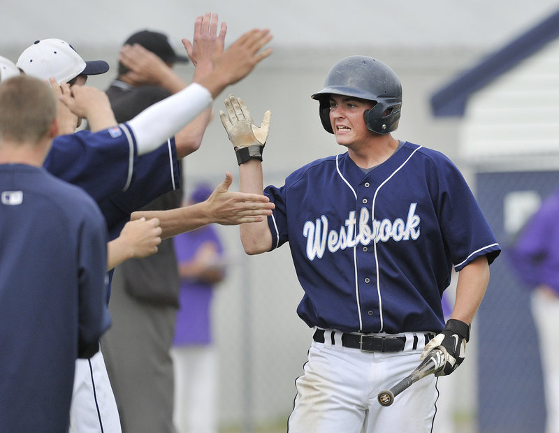 Derek Bouchard is greeted by his Westbrook teammates Thursday after scoring the sixth-inning run that proved the winner in a 3-2 quarterfinal victory against Cheverus.