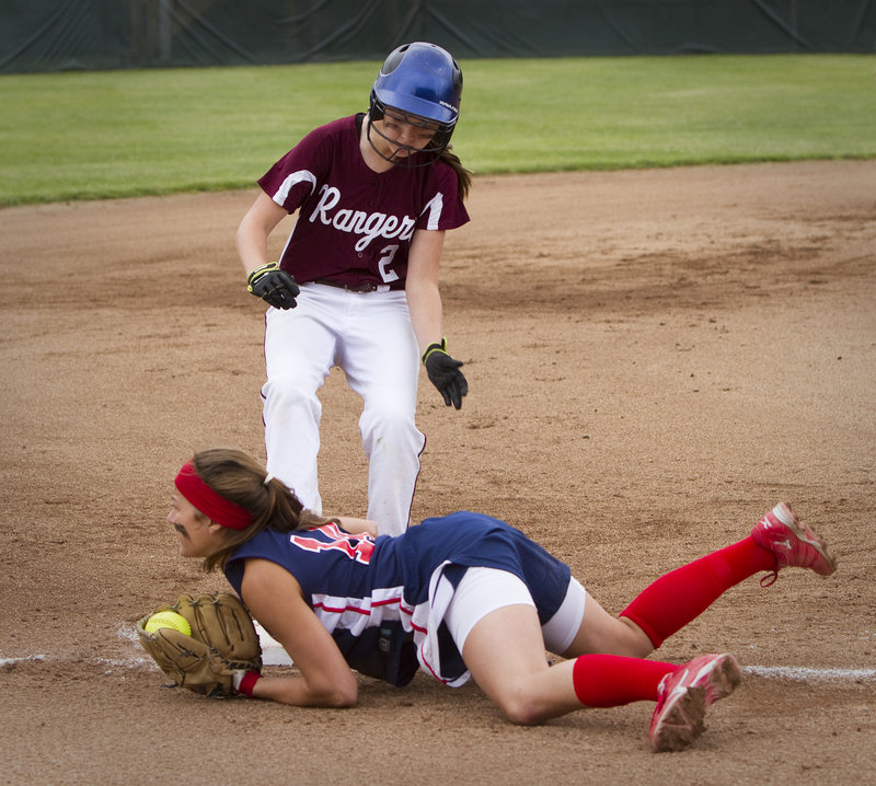 Samantha Wilkins of Gray-New Gloucester dives on third to force out Greely’s Evan Carrell in Wednesday’s game.