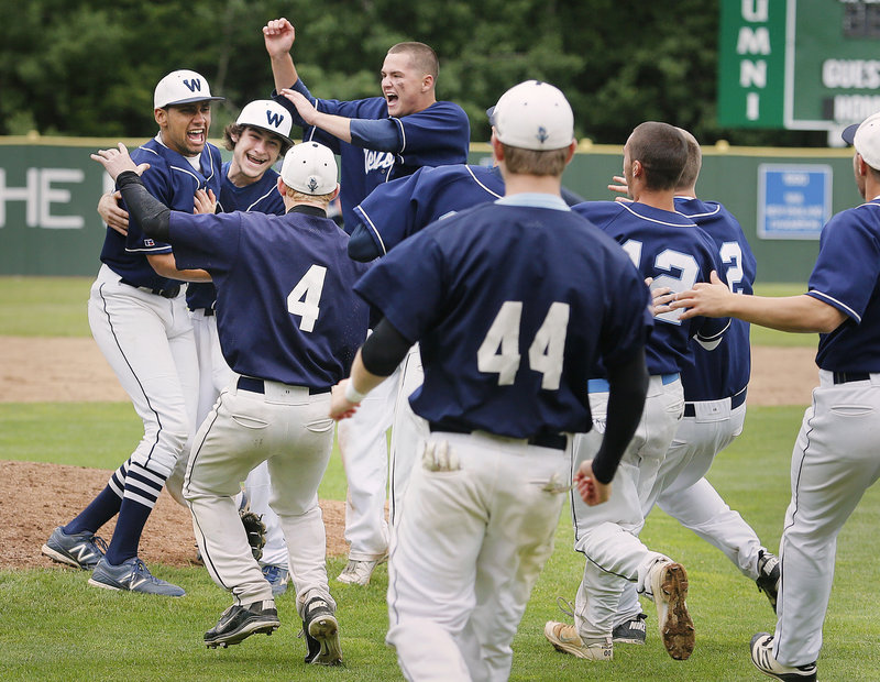 Keenen Lowe, left, is swarmed by his Westbrook teammates after completing a four-hit shutout Wednesday in a 5-0 win over Marshwood for the Western Class A title.