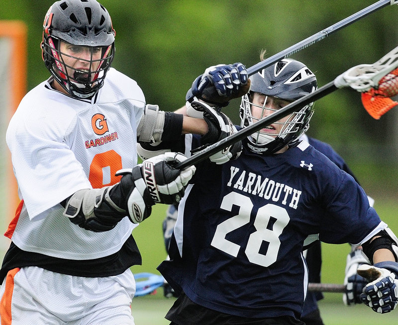 Gardiner’s Josh Moore, left, tries to get around Yarmouth’s Isaak Dearden in Wednesday’s Eastern Class B boys’ lacrosse championship game at Thomas College in Waterville. Yarmouth won, 15-3.