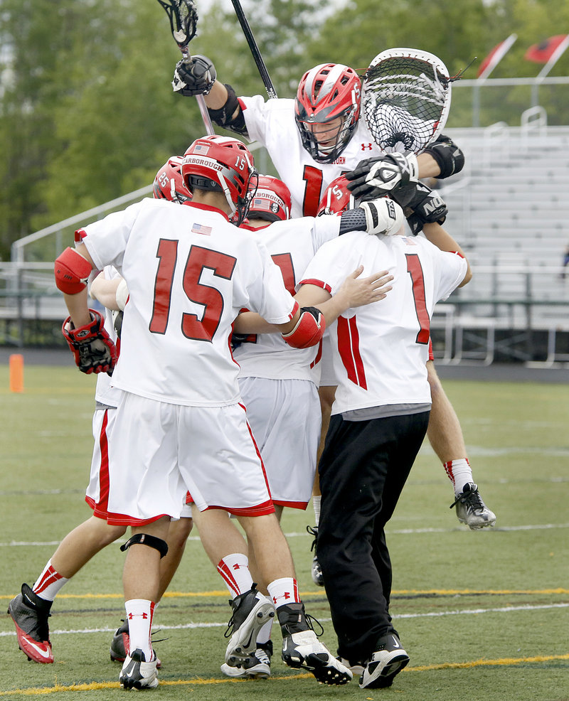 The Red Storm celebrate with goalie David Pearson (1) after an 11-3 win Wednesday over Kennebunk in the Western Class A boys’ lacrosse final at Scarborough.
