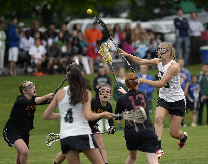 Martha Veroneau of Waynflete finds room to shoot Thursday between a group of Cape Elizabeth defenders. It was a familiar sight: Veroneau scored 10 goals as the Flyers captured the Western Class B girls’ lacrosse championship with a 16-9 victory.