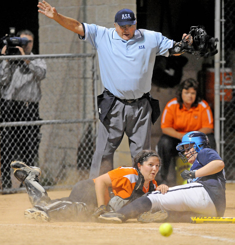 Kennadi Grover of Oceanside slides across the plate Thursday night as the ball gets away from Gardiner catcher Stephanie Plourd in the sixth inning of Oceanside’s 11-4 victory in the Eastern Class B softball final.