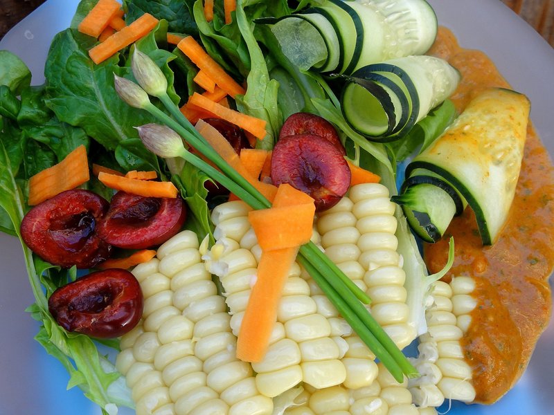 Green salad with corn, peppers and smoky red pepper dressing