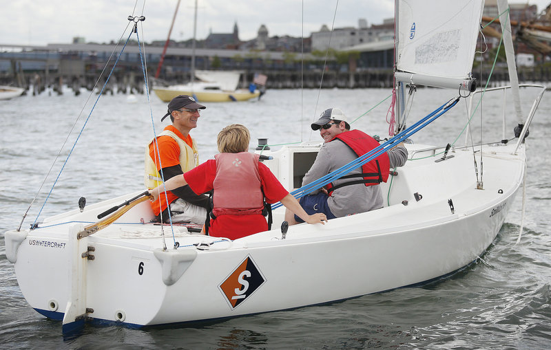 Volunteer skipper Jamie Carlson of Peaks Island takes a couple of visitors around Portland Harbor from Sail Maine’s base off the Eastern Promenade. Certified sailors can also rent the boats for $80 for a few hours of fun.