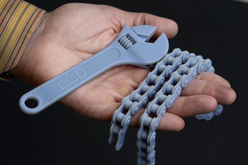 A wrench and a bicycle chain were created by 3-D printing at the Prototype Studio at Hallmark in Kansas City, Mo.