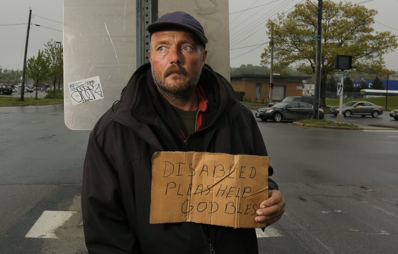 Don Dietz panhandles for change at Franklin Street and Marginal Way in Portland in May. A reader is skeptical about the concerns cited by people who favor a ban on panhandling in city medians.