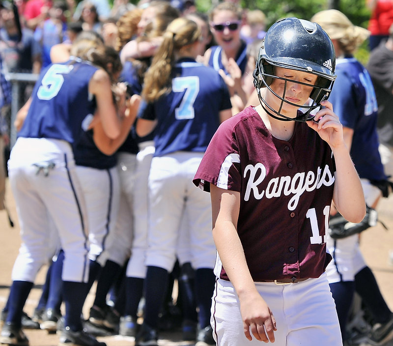 Sarah Felkel of Greely walks away as the game ends and Oceanside celebrates winning the Class B softball state championship at St. Joseph’s College.