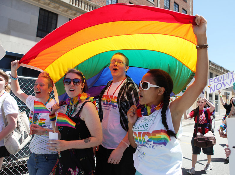 From left, Sandra Curry, Cassia Tirrell, Nathaniel Curry and Alizha Gagnon march during the annual Pride Parade in Portland on Saturday.