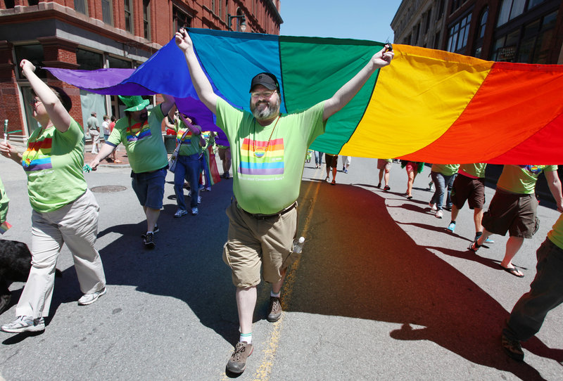 Dan Plourd of Portland helps carry a flag during the annual Pride Parade in Portland. Saturday’s event was the 27th annual Southern Maine Gay Pride Parade and Festival.
