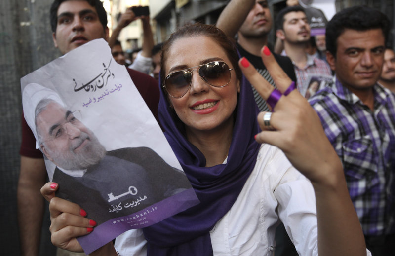 A supporter of Iranian presidential candidate Hasan Rowhani flashes a victory sign Saturday in Tehran.