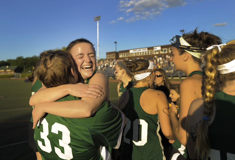 Katherine Torrey, 33, embraces teammate Isabel Agnew after Waynflete completed a perfect season with a 7-4 victory against Yarmouth in the Class B girls’ lacrosse state championship game at Fitzpatrick Stadium.