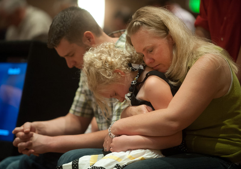 Lara Stern, right, prays with her daughter, Alana, 8, and her husband, Samuel, on Sunday after they lost their home to the Black Forest fire.