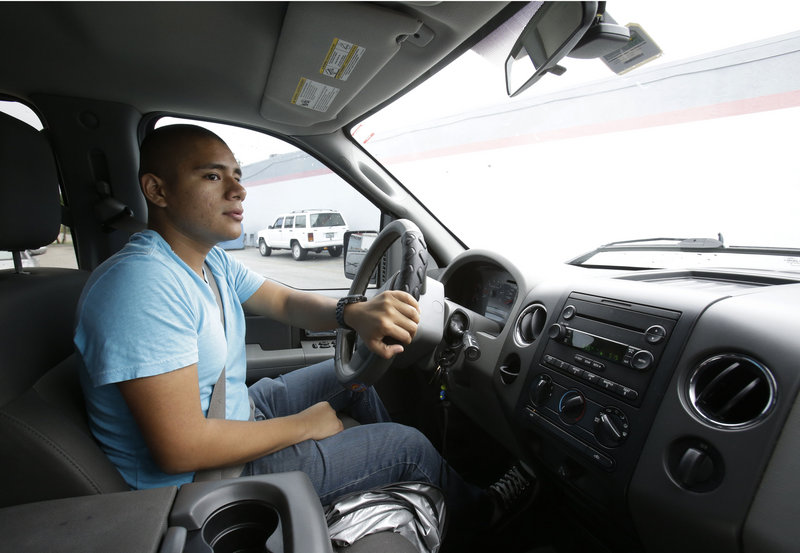 Francis Tume drives his truck in Miami, one year after President Obama announced an executive order allowing young people living in the United States illegally to stay and work.