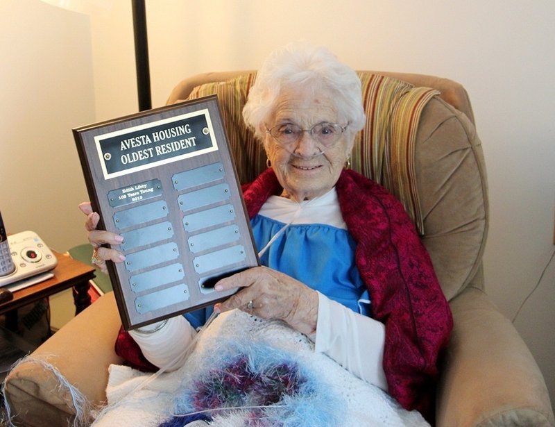Edith Libby holds a plaque presented to her in March as the oldest resident in all of Avesta’s 68 properties. Mrs. Libby died Saturday at age 102 after a brief illness.