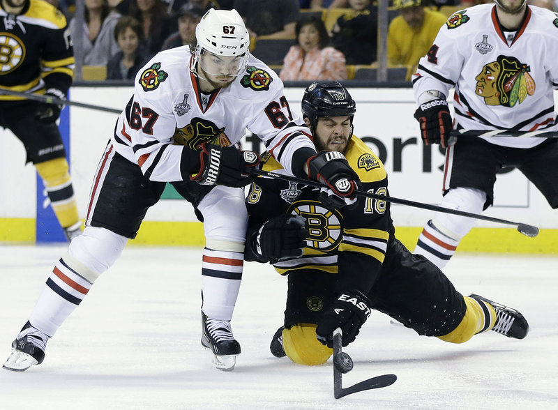 Paying the price is a huge part of playoff hockey. Nathan Horton of the Bruins knows that well as he goes to his knees to thwart Blackhawks center Michael Frolik in the second period Monday night in Boston.