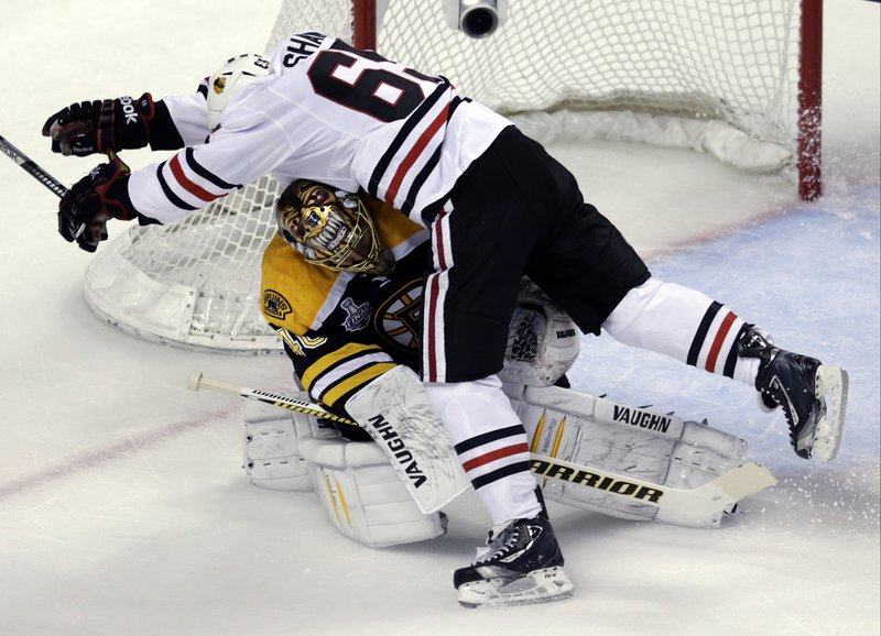 Bruins goalie Tuukka Rask gets slammed into by Chicago’s Andrew Shaw in the first period Monday night. No big deal. Rask made 28 saves as the Bruins took a 2-1 series lead in the Stanley Cup finals with a 2-0 win at Boston.