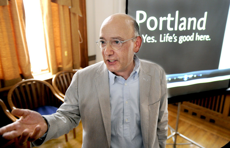Business owner David Puelle of Puelle Design joined other business leaders Tuesday, June 18, 2013 as the city of Portland unveiled its new slogan promote the city: "Portland, Maine. Yes. Life's good here."