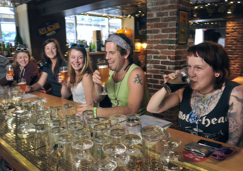 Customers – from left, Sarah Jump, Biz Wing, Erika Colby, Brian Gallant and Helen Walden – enjoy the selections at Novare Res Bier Cafe in Portland on Wednesday. A swarm of beer lovers is expected to visit the city this weekend.