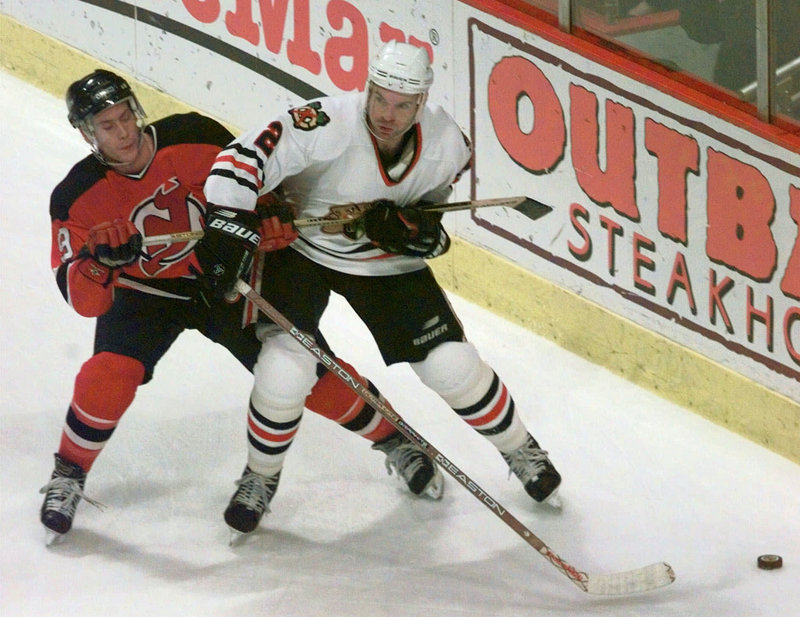 Eric Weinrich, right, who starred at North Yarmouth Academy and the University of Maine, plays for Chicago in 1998, the last of his five seasons with the Blackhawks.