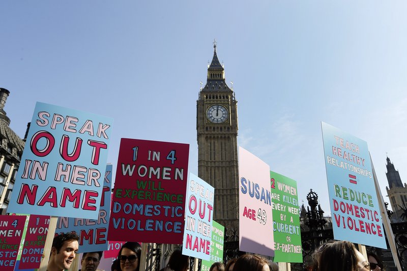 People hold banners during a demonstration against domestic violence near Big Ben in London in March, as part of events leading up to International Women’s Day.