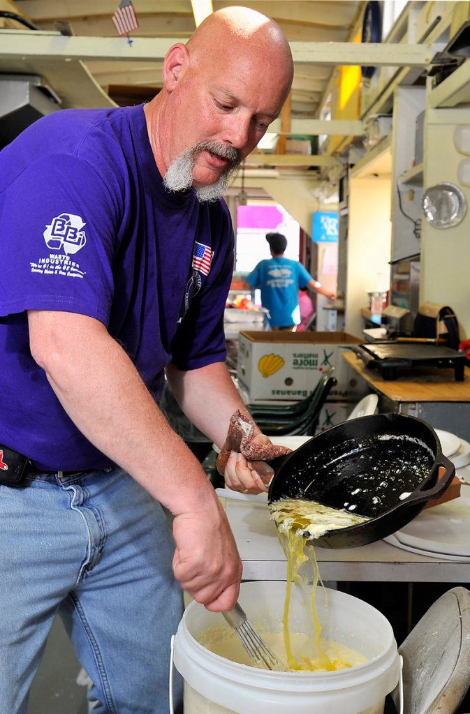 Guy Gosselin of Biddeford, crepe-maker extraordinaire, pours over a pound of melted butter from one of this seasoned cast iron skillets into one of his five-gallon buckets of batter he makes for the festival. Photographed on Thursday, June 20, 2013.
