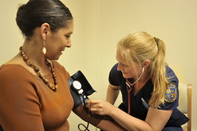 The Portland Community Health Center in Portland's Riverton Park, operated by the University of New England, will serve the immigrant, low-income and refugee communities. UNE student nurse Abby Pierce does a blood pressure check for Jessica Loney, of Bath, who attended the clinic's open house on Thursday, June 20, 2013.