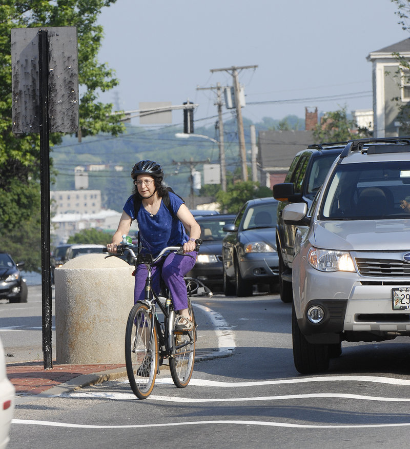 A bicycle commuter navigates traffic in Portland in 2008. A reader says, “I am a driver and a cyclist, and when in my car I see much more bad, rude and dangerous driving from other motorists than I ever do from cyclists.”