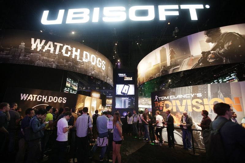 Attendees wait in line for presentations on two new video games, "Watch Dogs" and "Tom Clancy's The Division," during the Electronic Entertainment Expo in Los Angeles. Several games featured at the Expo are based on ripped-from-the-headlines themes.
