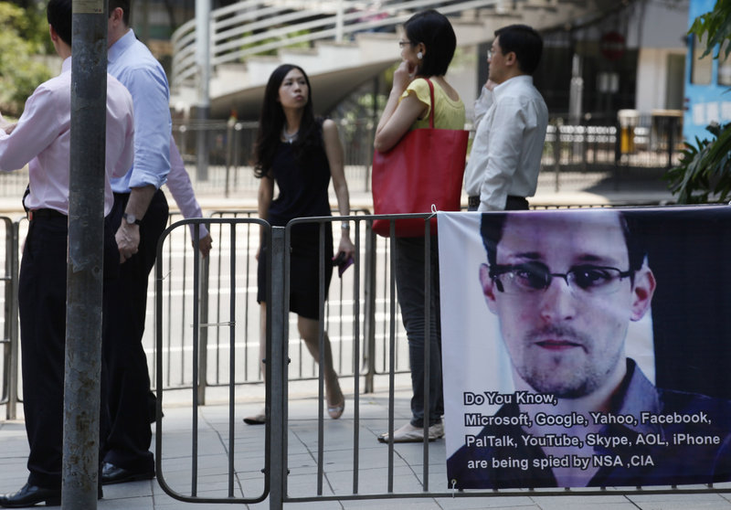 A banner supporting Edward Snowden, who leaked top-secret documents about sweeping U.S. surveillance programs, is displayed in Hong Kong’s business district Wednesday. Snowden has also leaked information about British surveillance operations.