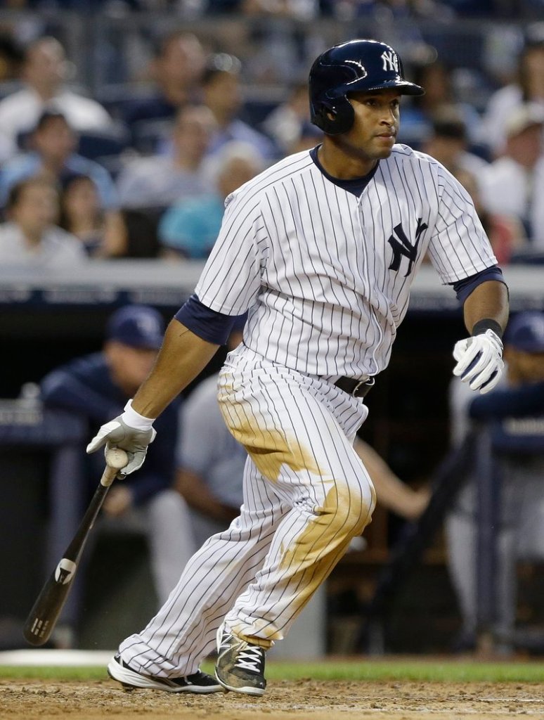 New York’s Zoilo Almonte strokes a single, one of his three hits during Friday night’s 6-2 victory over the Tampa Bay Rays. Almonte started in place of injured outfielder Vernon Wells.
