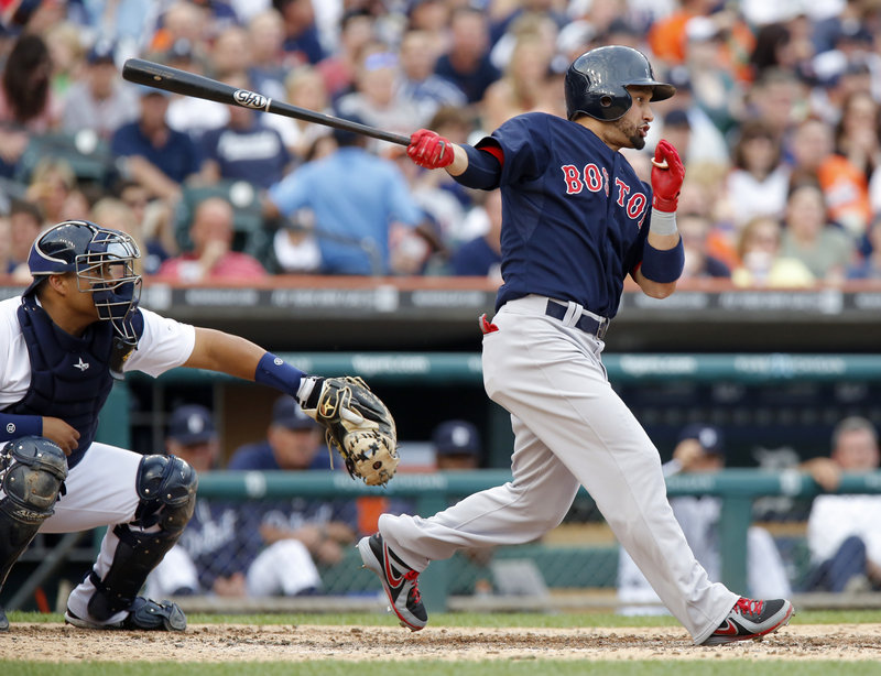 Shane Victorino follows through on a two-run single in the fourth inning Friday night, part of his five-RBI game that helped the Boston Red Sox provide Jon Lester with a victory, downing the Detroit Tigers, 10-6.