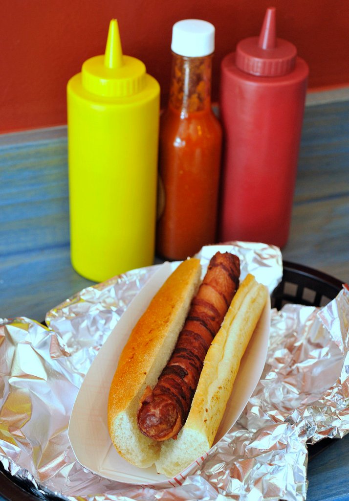 The Blue Rooster in Portland offers a variety of interesting hot dog toppers – not to mention bacon-wrapped dogs.