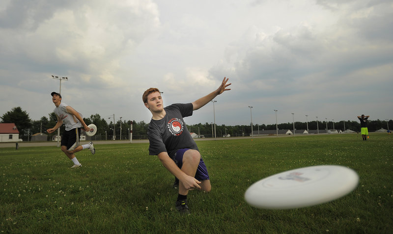Ben Smith of Portland, soon to be a freshman at the University of Maine, throws a disc during warm-ups before a Portland Ultimate Adult Summer League game Tuesday at the Cumberland County Fairgrounds, the site of eight games on this night.
