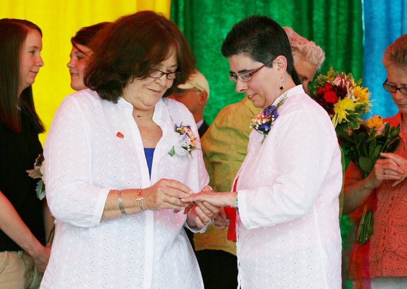Rose Larkin, left, puts a ring on Deb DeTuccio’s finger June 15 during a mass wedding held in Deering Oaks in Portland as part of the Southern Maine Pride Festival. The highest court in the land has struck down part of a law that prevents the federal government from recognizing the marriages of couples married in states like Maine that don’t discriminate.
