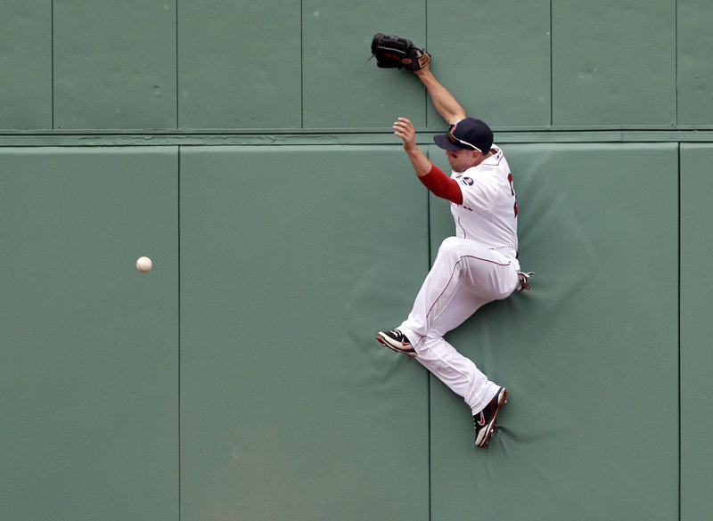 Boston center fielder Jacoby Ellsbury jumps against the wall but cannot catch Todd Helton’s drive, which went for a double in the top of the fourth inning.